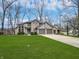 Charming two-story home with well-manicured lawn and a three-car garage and a basketball hoop at 1242 Bitterwood Ct, Columbus, IN 47201