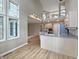Open concept kitchen with views to the upstairs, an island with seating, and modern appliances at 1242 Bitterwood Ct, Columbus, IN 47201