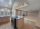 Open kitchen featuring light wood cabinetry, an island, and views of the living room at 1242 Bitterwood Ct, Columbus, IN 47201