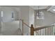 Open landing area showcases natural light from a skylight, a geometric chandelier and staircase at 1242 Bitterwood Ct, Columbus, IN 47201