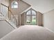 Spacious living room featuring high ceilings, large windows, and carpet flooring at 1242 Bitterwood Ct, Columbus, IN 47201