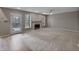 Spacious living room with a fireplace, neutral walls, carpet flooring, and access to the backyard at 1242 Bitterwood Ct, Columbus, IN 47201