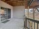 Covered patio features sliding glass door to finished basement, and view of backyard at 1242 Bitterwood Ct, Columbus, IN 47201
