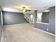 Spacious living area featuring neutral carpet, gray walls, and a ceiling fan for comfortable living at 15314 Clear St, Noblesville, IN 46060