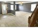 Bright living area with carpet, gray walls, and natural light, with the front door visible at 15314 Clear St, Noblesville, IN 46060