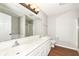 Bright bathroom featuring double sinks, a large mirror, and wood flooring at 4007 Bullfinch Way, Westfield, IN 46062