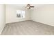 Inviting bedroom with soft carpet, ceiling fan, and a window offering natural light and neighborhood view at 4007 Bullfinch Way, Westfield, IN 46062