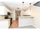 The kitchen has white cabinetry, a breakfast bar, and direct access to the laundry room at 4007 Bullfinch Way, Westfield, IN 46062