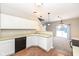 Bright eat-in kitchen features white cabinets, laminate countertop, and direct view of living room at 4007 Bullfinch Way, Westfield, IN 46062