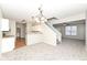 Inviting living room open to kitchen with hanging lights and stairway at 4007 Bullfinch Way, Westfield, IN 46062