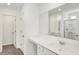 Bright bathroom with white cabinets, double sinks, and tiled floors at 67 Sterling Pl, New Whiteland, IN 46184