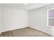 Bright bedroom featuring neutral carpet, white walls, and a window for natural light at 67 Sterling Pl, New Whiteland, IN 46184