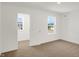 Empty bedroom displaying large windows and a door for easy access to other areas at 67 Sterling Pl, New Whiteland, IN 46184