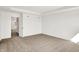 A bedroom with neutral carpet and walls, recessed lights, and access to the bathroom and hallways at 67 Sterling Pl, New Whiteland, IN 46184