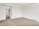 A carpeted bedroom with neutral walls has a door to a hallway at 67 Sterling Pl, New Whiteland, IN 46184