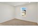 Empty bedroom showcases a window overlooking the neighborhood at 67 Sterling Pl, New Whiteland, IN 46184