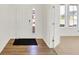 Bright entryway features a modern door with glass, wood-look flooring, and neutral walls at 67 Sterling Pl, New Whiteland, IN 46184