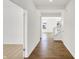 Bright hallway with hardwood floors, leading to staircase and carpeted room at 67 Sterling Pl, New Whiteland, IN 46184