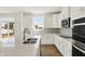 Bright kitchen featuring white cabinetry, stainless steel appliances, and a large island with a double sink at 67 Sterling Pl, New Whiteland, IN 46184