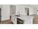 Stylish kitchen island with stainless steel dishwasher, sink, and ample counter space for meal preparation at 67 Sterling Pl, New Whiteland, IN 46184