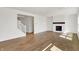 Spacious living room with a fireplace, hardwood floors, and staircase to the second floor at 67 Sterling Pl, New Whiteland, IN 46184