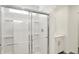 A stylish shower with white tiles and a glass enclosure; a vanity can be seen in the background at 67 Sterling Pl, New Whiteland, IN 46184
