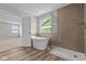 Bright bathroom featuring a glass shower and a free standing tub at 10603 Banyan Wood Ct, Indianapolis, IN 46239