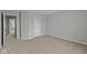 Bedroom featuring neutral carpet, an adjacent room and a door at 10603 Banyan Wood Ct, Indianapolis, IN 46239