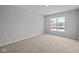 A spacious bedroom showcasing a large window offering views of the neighborhood at 10603 Banyan Wood Ct, Indianapolis, IN 46239