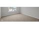 Bedroom featuring neutral walls, carpet, and a window, offering a comfortable and adaptable space at 10603 Banyan Wood Ct, Indianapolis, IN 46239