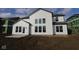 The back of this two-story home with white siding, a black roof, and a patio at 10603 Banyan Wood Ct, Indianapolis, IN 46239