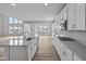 Modern kitchen featuring an island, new stainless steel appliances, and wood flooring at 10603 Banyan Wood Ct, Indianapolis, IN 46239