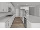 Modern kitchen featuring new stainless steel appliances, white cabinets, and wood flooring at 10603 Banyan Wood Ct, Indianapolis, IN 46239