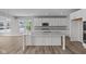 Modern kitchen featuring an island, new stainless steel appliances, and white cabinets at 10603 Banyan Wood Ct, Indianapolis, IN 46239