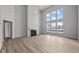 Spacious living room with a fireplace, tall windows, and gorgeous wood floors at 10603 Banyan Wood Ct, Indianapolis, IN 46239