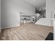 Bright, open-concept living room flows into the kitchen, featuring wood floors and a staircase at 10603 Banyan Wood Ct, Indianapolis, IN 46239