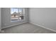 Bright bedroom with a large window overlooking the neighborhood and plush neutral carpeting at 3509 Wrangler Dr, Bargersville, IN 46106