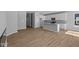 Open-concept kitchen boasts a central island, wood flooring, and pristine white cabinetry at 3509 Wrangler Dr, Bargersville, IN 46106
