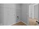 Well-lit laundry room with wood-look floors and shelving for storage, plus washer/dryer hookups at 3509 Wrangler Dr, Bargersville, IN 46106