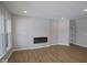 Modern living room featuring hard wood floors, an electric fireplace and ample lighting fixtures at 3509 Wrangler Dr, Bargersville, IN 46106