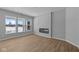 Bright room with luxury vinyl plank flooring, large windows, and a modern electric fireplace at 3509 Wrangler Dr, Bargersville, IN 46106