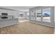 Modern open living space with luxury vinyl plank flooring, stainless steel appliances, and expansive windows at 3509 Wrangler Dr, Bargersville, IN 46106