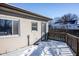 Small back patio with wooden deck and steps, covered in snow at 4934 Manker St, Indianapolis, IN 46227