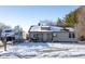 Tan house with snow covered roof and yard, white front door, RV parked next to home, chain link fence at 4934 Manker St, Indianapolis, IN 46227