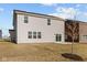 Home's backyard featuring a sliding door with a large yard and minimal landscaping at 6114 Paperbark Way, Indianapolis, IN 46259