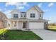 Charming two-story home featuring a two-car garage, covered porch, and tasteful architectural detailing at 6114 Paperbark Way, Indianapolis, IN 46259