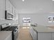 Bright, open kitchen features modern appliances and a large island with quartz countertops at 6114 Paperbark Way, Indianapolis, IN 46259