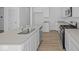 Close-up of the kitchen featuring stainless steel appliances, island, and modern countertops at 6114 Paperbark Way, Indianapolis, IN 46259