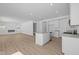 Modern kitchen with stainless steel appliances, white cabinetry, and an island at 6114 Paperbark Way, Indianapolis, IN 46259