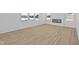 Bright living room showcasing wood flooring, large windows, and modern fireplace at 6114 Paperbark Way, Indianapolis, IN 46259
